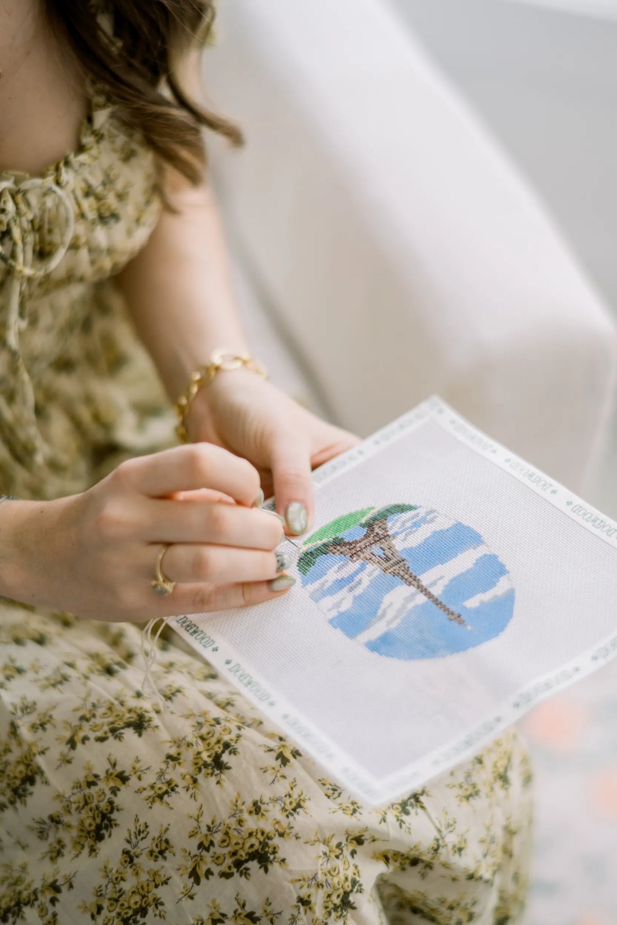 Hand stitching the Eiffel Tower design on a Dogwood Needlepoint canvas